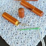 A polished timber darning wool needle case. With screw on lid. Perfect for all knitting, sewing, quilting and crochet projects. Includes 4 needles of various size.