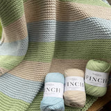 Fiddlesticks Finch 10 ply Cotton Yarn. Striped knit blanket in green, blue and beige yarn.