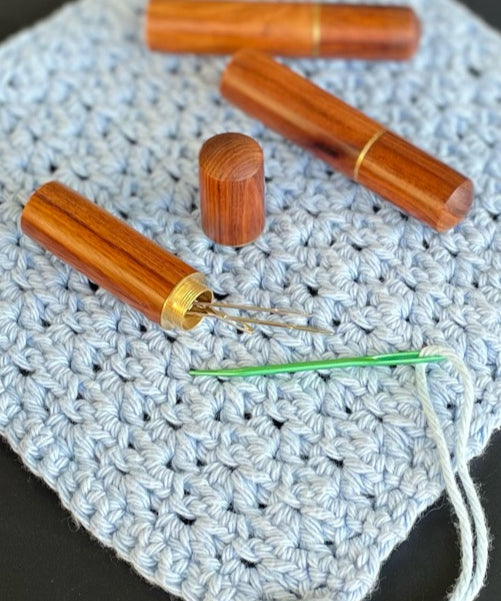 A polished timber darning wool needle case. With screw on lid. Perfect for all knitting, sewing, quilting and crochet projects. Includes 4 needles of various size.